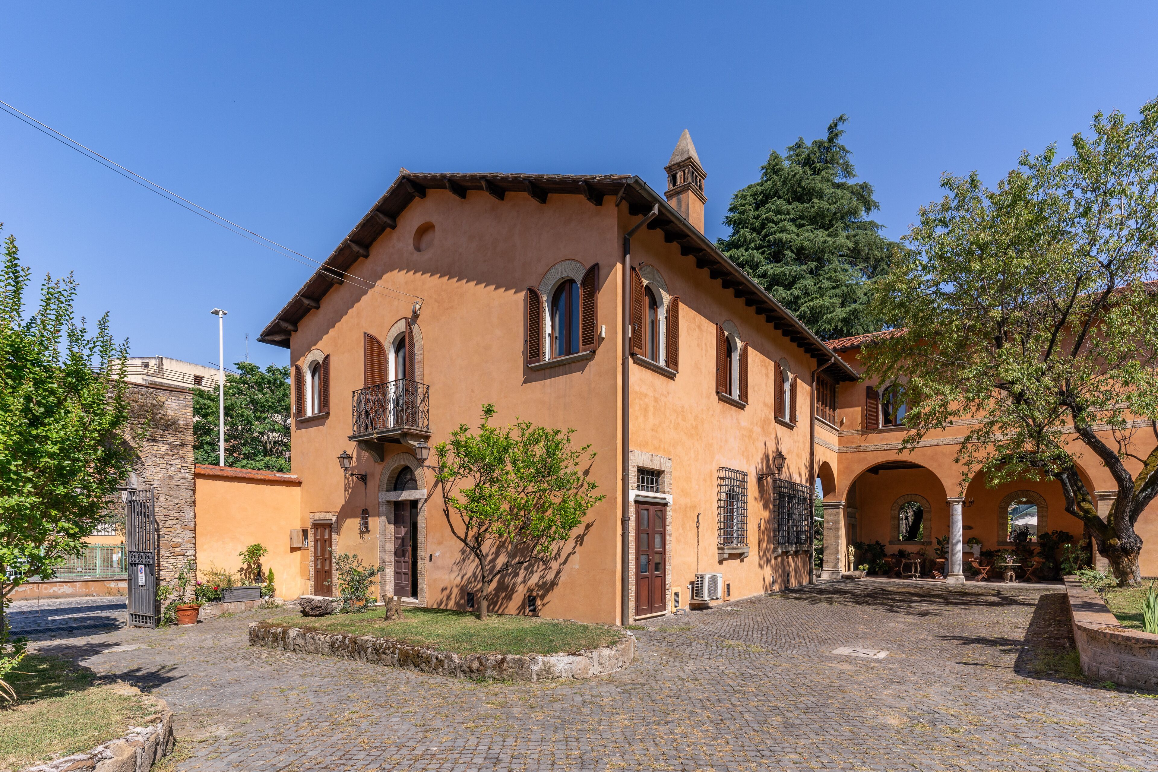 A traditional building with a courtyard, stone walls, and arched doorways.