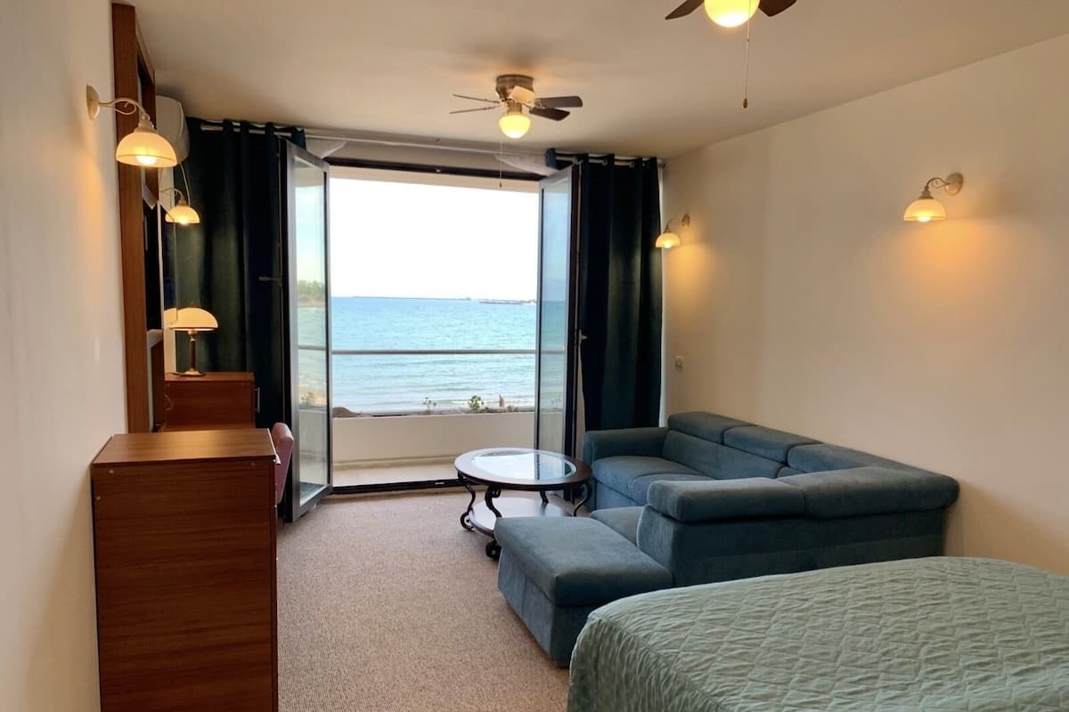 Deluxe Room, Balcony, Sea View | In-room safe, desk, blackout drapes, iron/ironing board