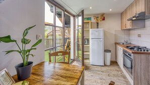 A modern kitchen with wooden cabinets, a built-in stove, and a white refrigerator.