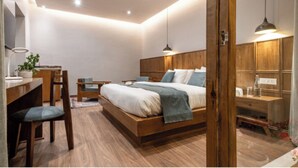 Un dormitorio moderno con cama de madera, mesitas de noche, un escritorio y una silla.