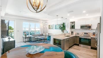 Fridge, coffee/tea maker, cookware/dishes/utensils, dining tables