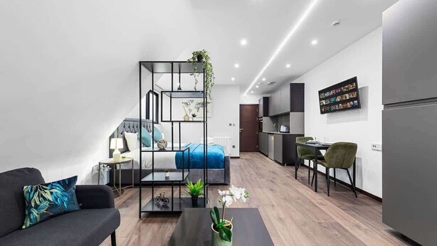 A modern apartment with a living area, a dining space, and a kitchen.