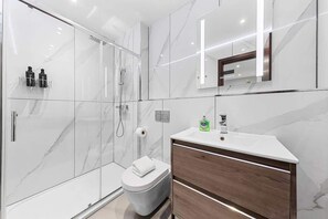 Shower, hair dryer, towels, shampoo