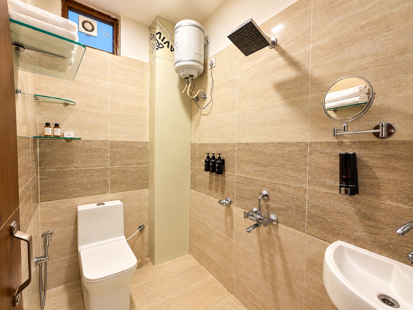A modern bathroom with a toilet, bidet, shower, and sink.