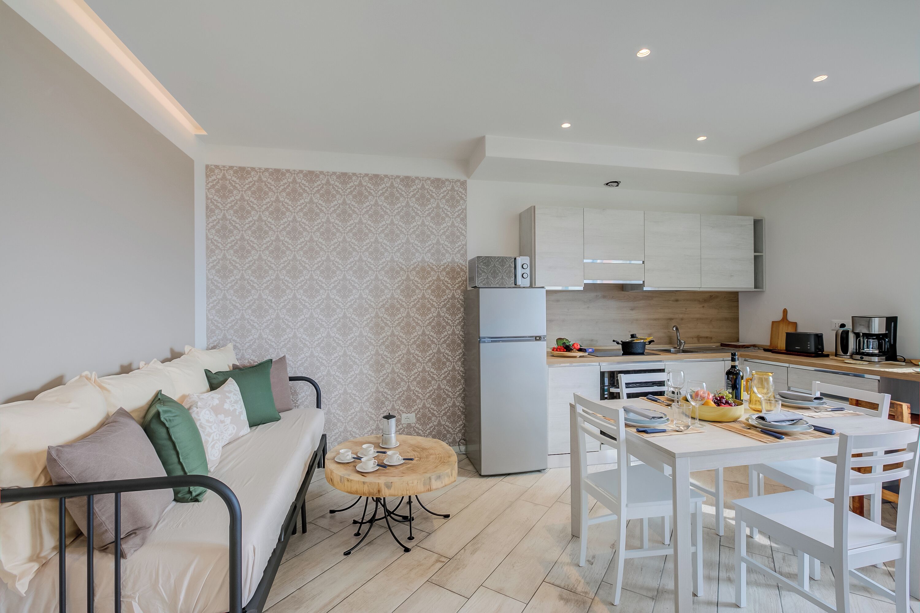 A modern apartment with a living area, a dining table, and a kitchen.