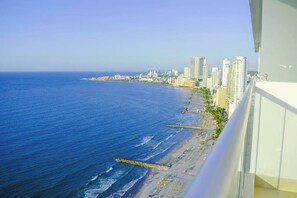 A coastal cityscape with high-rise buildings, a beach with umbrellas, and a clear blue sky. - SPECTACULAR Jewel @ Palmetto Beach Bocagrande 32th Floor (Cartagena de Indias)
