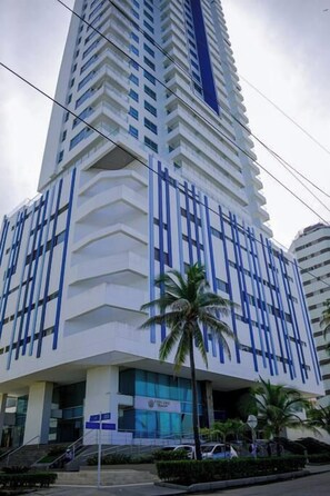 A tall, modern building with a white facade and blue accents, featuring a prominent entrance with a staircase. - SPECTACULAR Jewel @ Palmetto Beach Bocagrande 32th Floor (Cartagena de Indias)