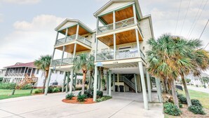 A two-story building with balconies and a covered front porch.