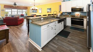 A kitchen with granite countertops, white cabinets, and stainless steel appliances. - 2nd Row 4 BR Beach House with a Private Pool! Peachy Pleasure   (Surfside Beach)