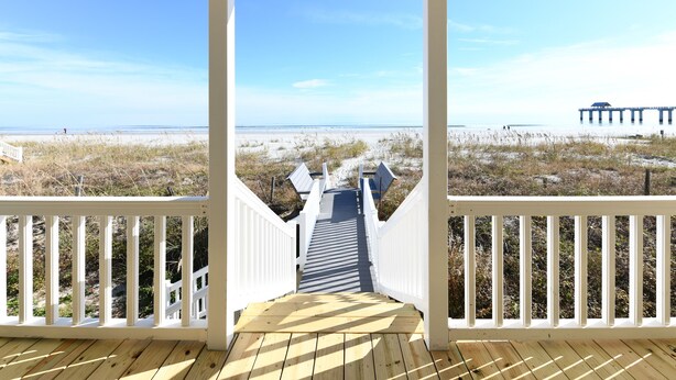 A wooden deck leading to a beach with a pier in the background. - Oceanfront 5 BR Beach House! Sam's Shack (Surfside Beach)