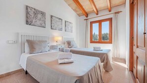 A hotel room with two beds, a window with curtains, and artwork on the wall. - Finca Vilar with pool, garden, 6 bedrooms, with A/C, 4 bathrooms, free Wifi (IB)