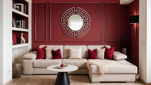 A modern living room with a sectional sofa, a round coffee table, and a decorative wall piece. - Qult·co - Old City Pearl (București)
