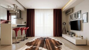 A modern kitchen with a dining area, a large window with curtains, a flat-screen TV, and a mounted plant. - Qult·co - Old City Pearl (București)