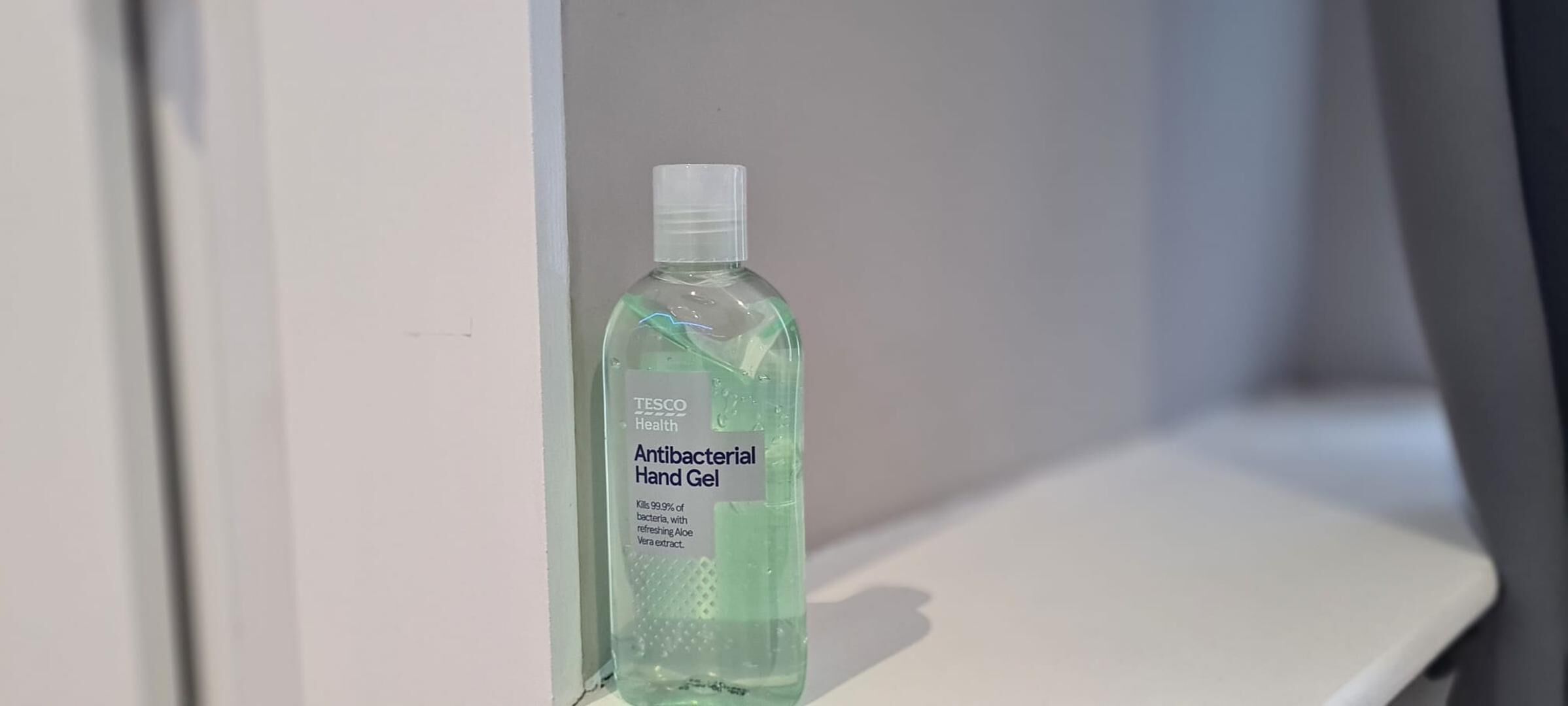 A bottle of Tesco Health Antibacterial Hand Gel on a white surface.