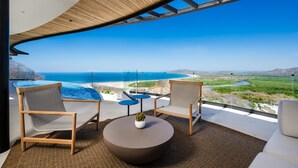 A modern outdoor seating area with a view of the ocean and a pool. - Modern 6 BR Ocean View Villa with pingpong table, daily breakfast & cleaning (Playa Tamarindo)