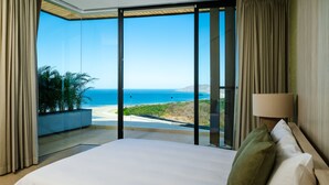 A bedroom with a large bed, a view of the ocean, and a balcony with curtains. - Modern 6 BR Ocean View Villa with pingpong table, daily breakfast & cleaning (Playa Tamarindo)