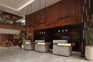 A modern hotel lobby with a wooden reception desk, a seating area, and a mezzanine level. - Courtyard by Marriott Casablanca Downtown (Casablanca)