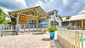 A covered outdoor area with a pool, wooden deck, and seating. - Near State Parks: Carrabelle Home w/ Beach Access! (Carrabelle)