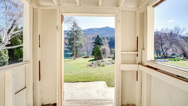 An interior hallway leading to a view of a mountainous landscape. - Idyllic Rock Island Home w/ Columbia River Views (Rock Island)