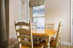 A dining area with a wooden table and four chairs. - Beautiful 5 Bed Pool Home In Reunion 5 Bedroom Home by RedAwning (Kissimmee)
