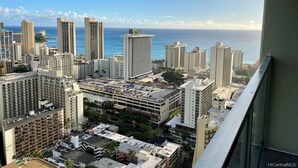 A high-rise building with a view of the ocean and other buildings. - Glam Condo Located in Central Waikiki, Panoramic Ocean View, & Full Kitchen!
 (Honolulu)