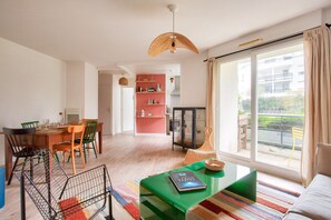 Enjoy a spacious living area with a sliding glass door leading to a balcony offering views of the surrounding area.