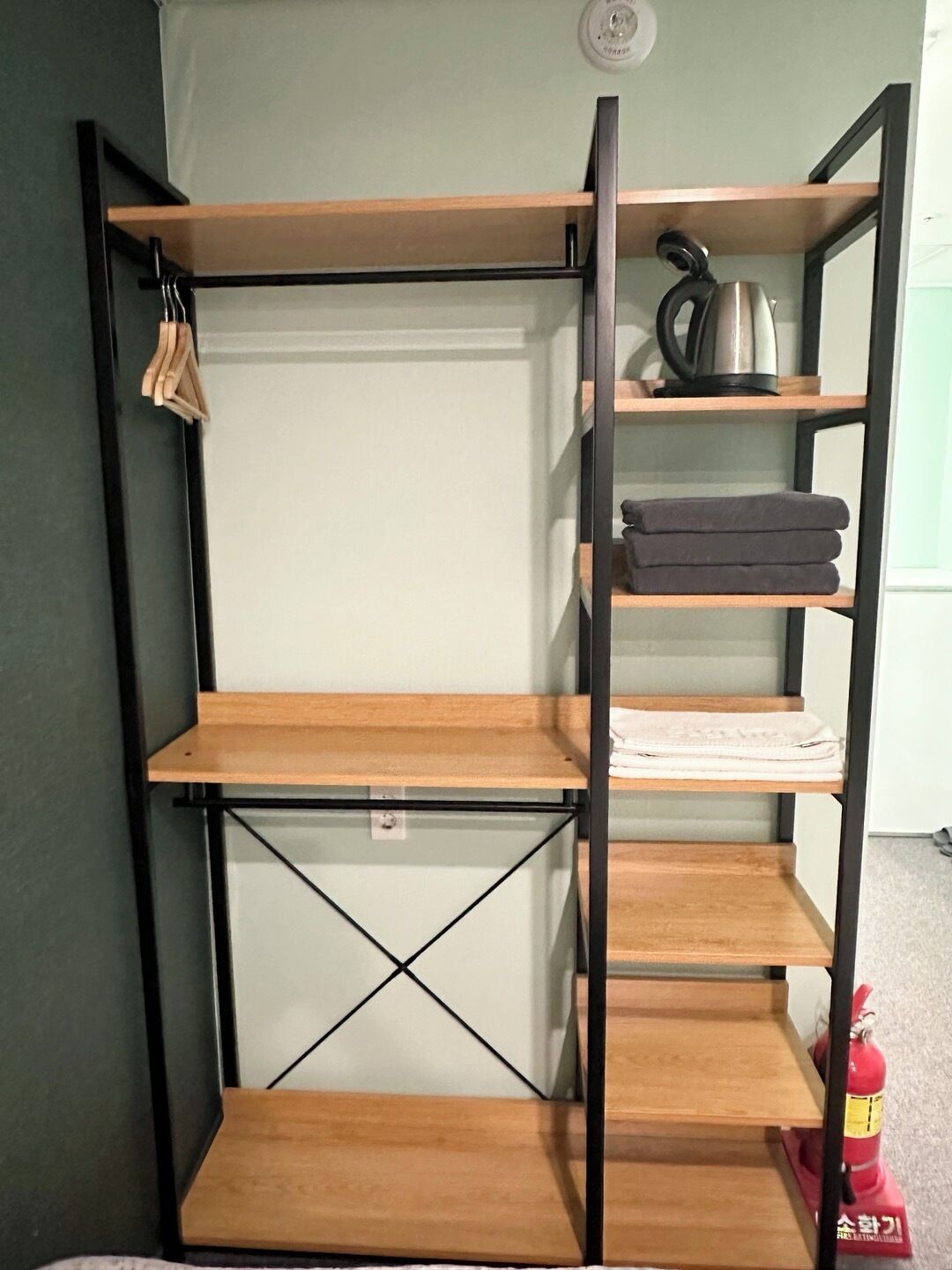 A bunk bed with wooden shelves and a metal frame.