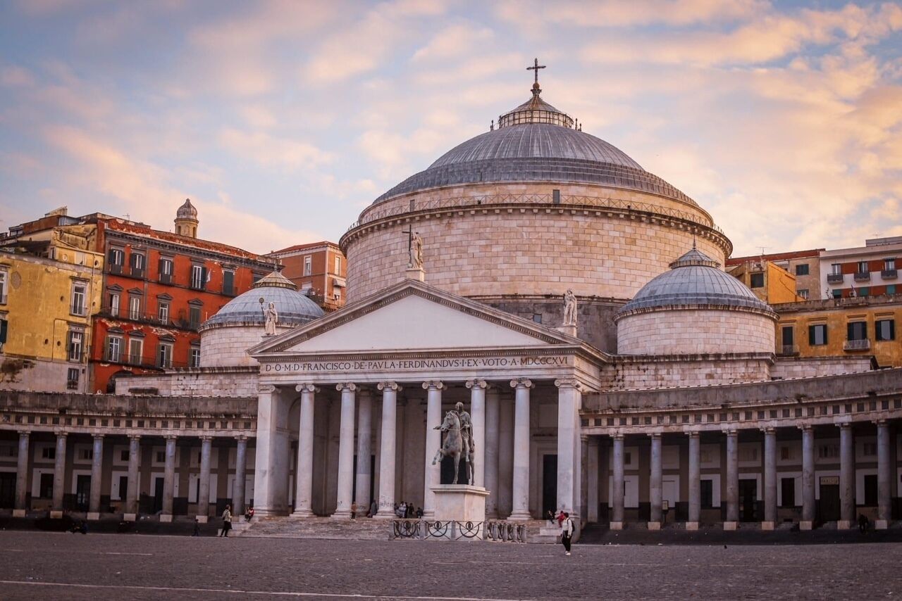 A historic building with a central dome and classical columns.
