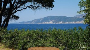 A table with a view of the sea and mountains.