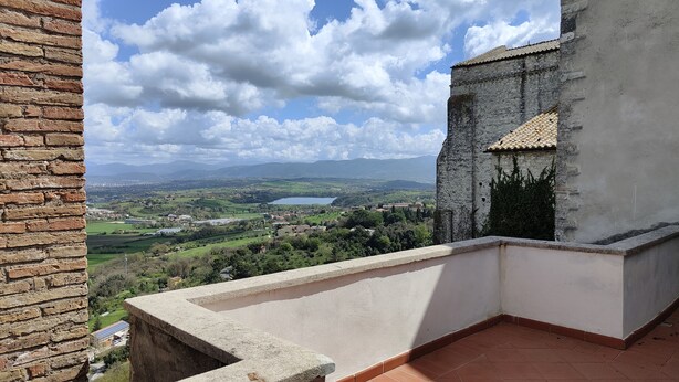 A balcony with a view of a town, a body of water, and distant mountains. - Green Heart Terrace - Newly renovated attic in the historic center of Narni (Narni)