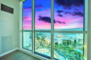 Enjoy a panoramic city view from the large window, featuring a split design showcasing the urban landscape.