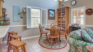 A dining area with a round table, wooden chairs, and a patterned rug. - 8 Mi to Lake Lure! Mtn-View Gem w/ Furnished Deck (Rutherfordton)