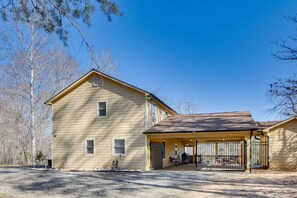 A two-story house with a covered porch and a garage. - 8 Mi to Lake Lure! Mtn-View Gem w/ Furnished Deck (Rutherfordton)
