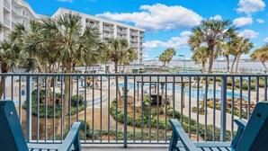 A resort with a pool area, palm trees, and a white building with balconies. - Beach Access, Pool/Hot Tub, Sleeps 5 - Vet Owned (Gulf Shores)