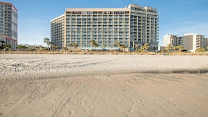 A large, multi-story hotel with a modern design, featuring numerous balconies and a beach view. - Spacious 3 Bedroom Oceanview Condo at Sand Dunes Resort (Myrtle Beach)
