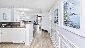 A spacious kitchen with granite countertops, white cabinetry, and a dishwasher. - Spacious 3 Bedroom Oceanview Condo at Sand Dunes Resort (Myrtle Beach)
