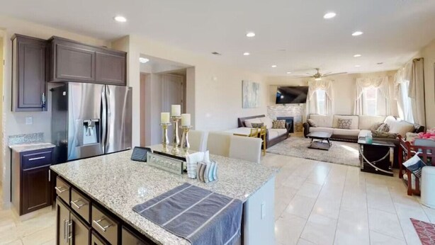 A spacious living area with a kitchen, a dining area, and a seating area with sofas and a TV. - King Beds Castle | Air Hockey | Room TVs | Firepit (Chico)