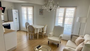 A spacious living area with a dining table, a comfortable armchair, a sofa, and a glass coffee table. - Beautiful view Walking distance from the center (Nice)