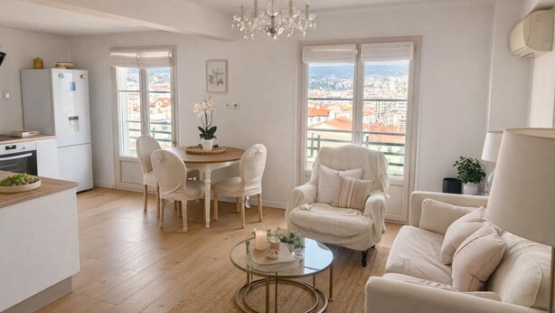 A modern apartment with a dining area, a living room with a sofa and armchair, a kitchen with a refrigerator, and large windows offering a city view. - Beautiful view Walking distance from the center (Nice)