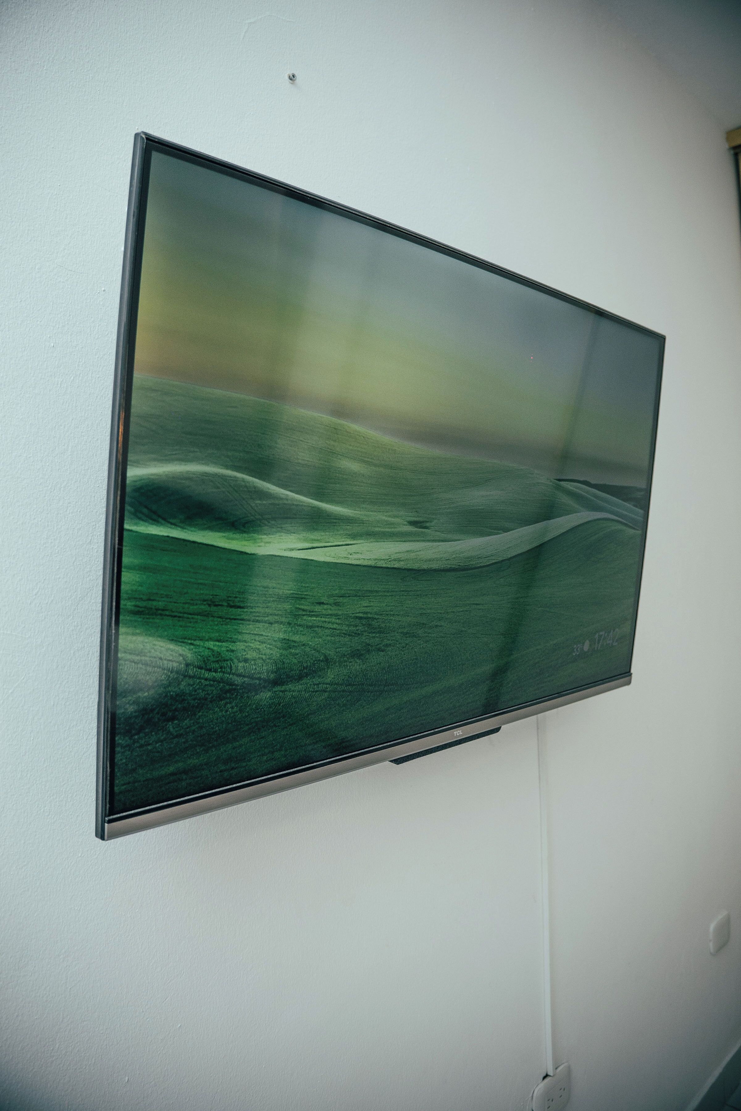 A flat-screen TV mounted on a white wall.