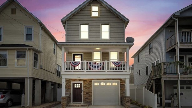 A two-story house with a front porch and a garage. - Beach Block Family House w/Garage & Decks (Sea Bright)