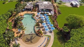 An aerial view of a resort with a swimming pool, sun loungers, and tennis courts. - Remodeled #56,  AC, grnd flr end unit, ideal location! (Koloa)