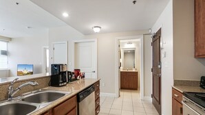A modern kitchen with granite countertops, stainless steel appliances, and wooden cabinets.