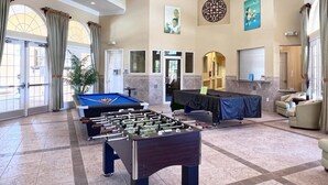 A spacious lobby with a foosball table, a pool table, and comfortable seating areas. - Spacious and Relaxing Home with South Facing Pool (Davenport)