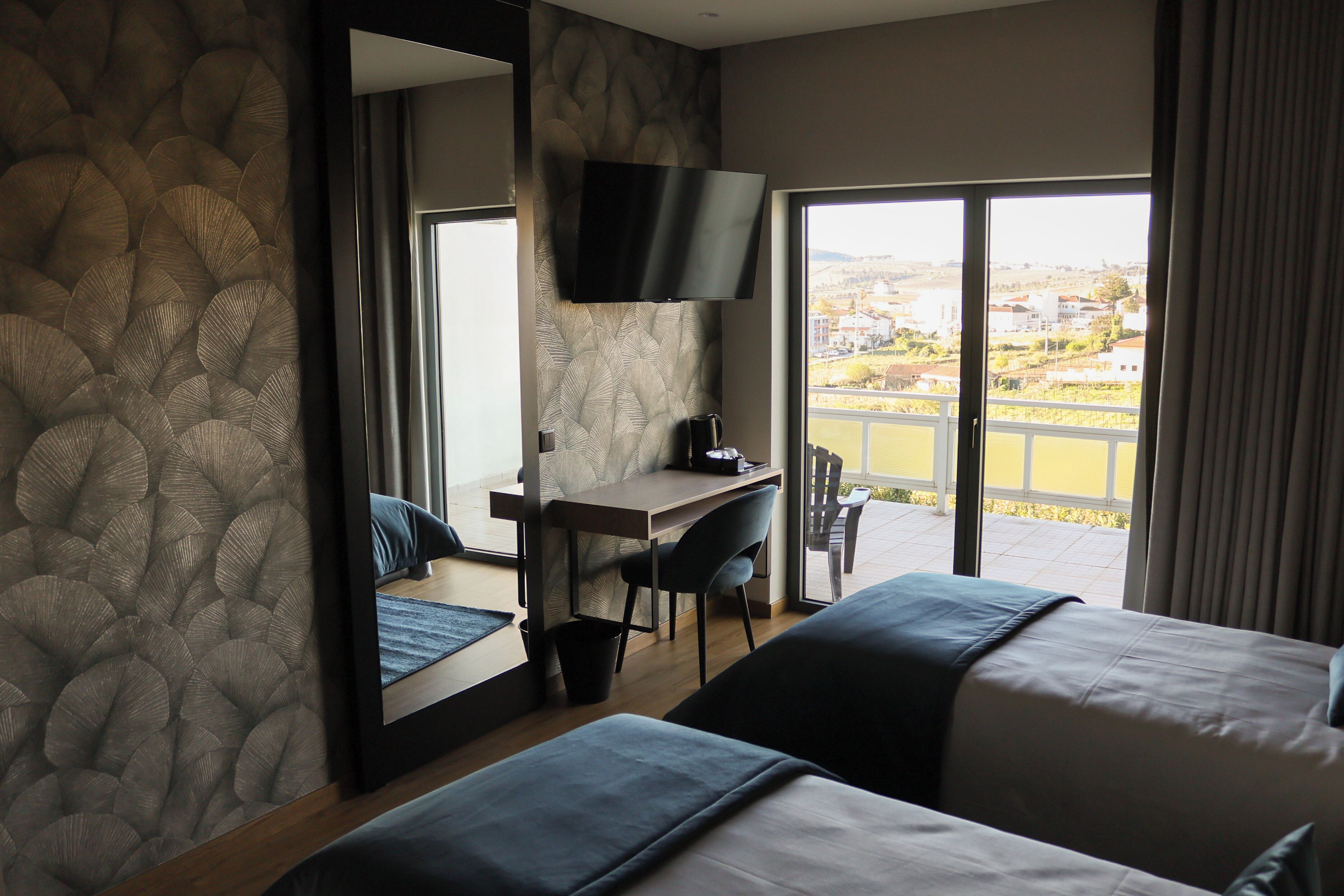 Deluxe Double or Twin Room | Desk, laptop workspace, blackout drapes, free WiFi