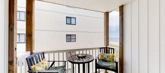 Third-floor beachfront retreat with furnished balcony, pool, washer/dryer