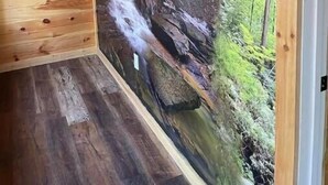 A room with wooden walls and a large mural of a waterfall. - Unwind at Whispering Woods / Hot Tub, Waterfall, Arcade & Nature (camton)