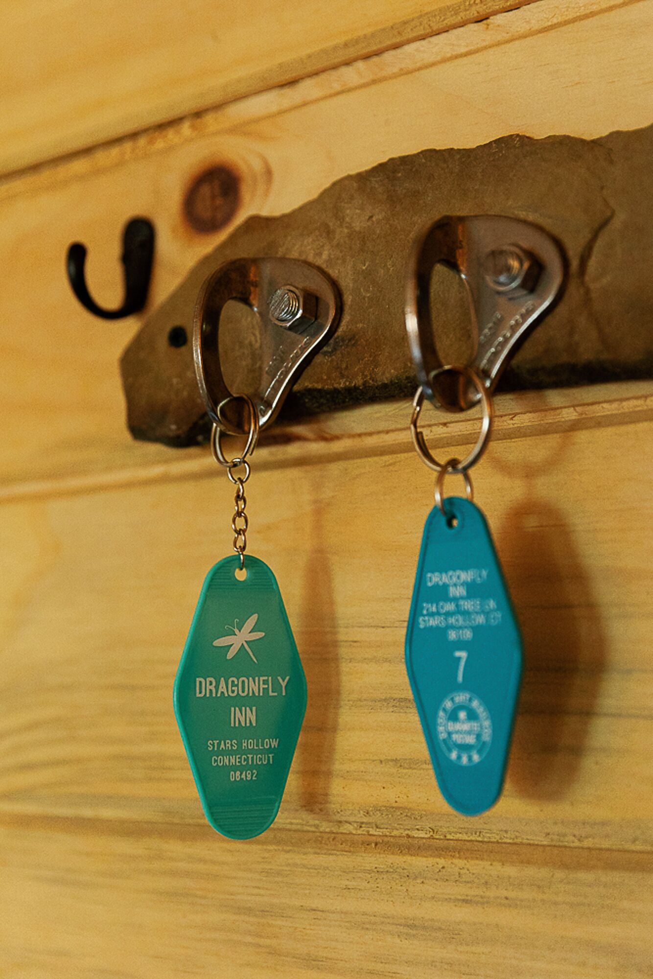 A pair of keychains with the Dragonfly Inn logo and address.