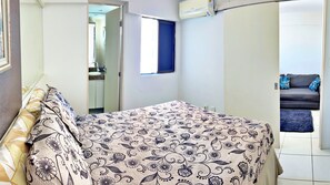 Relax in this cozy space with a comfortable bed and seating area, perfect for unwinding.
