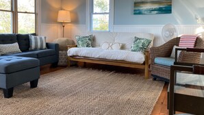 A cozy living room with a sofa, a daybed, a lamp, and a painting on the wall. - Attached Apartment Near It All. Organic Farmstead. Stunning Views. Pet-friendly. (New Shoreham)
